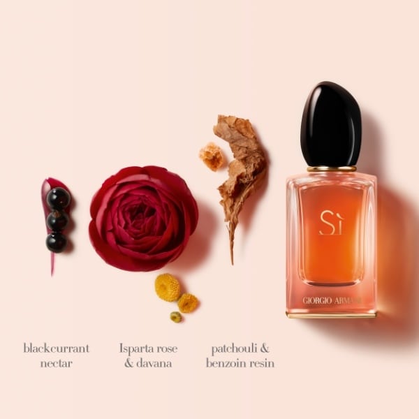Perfume bottle with floral elements on a light pink background