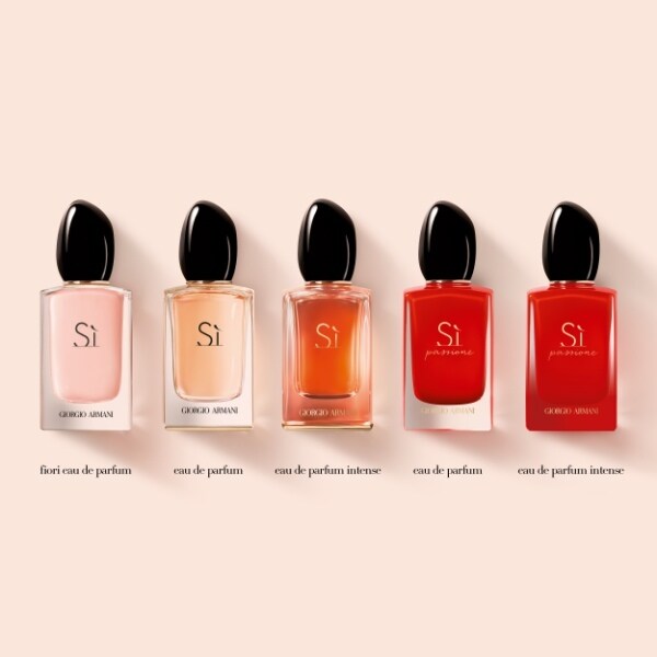 Five Giorgio Si perfume bottles in various colors on a beige background