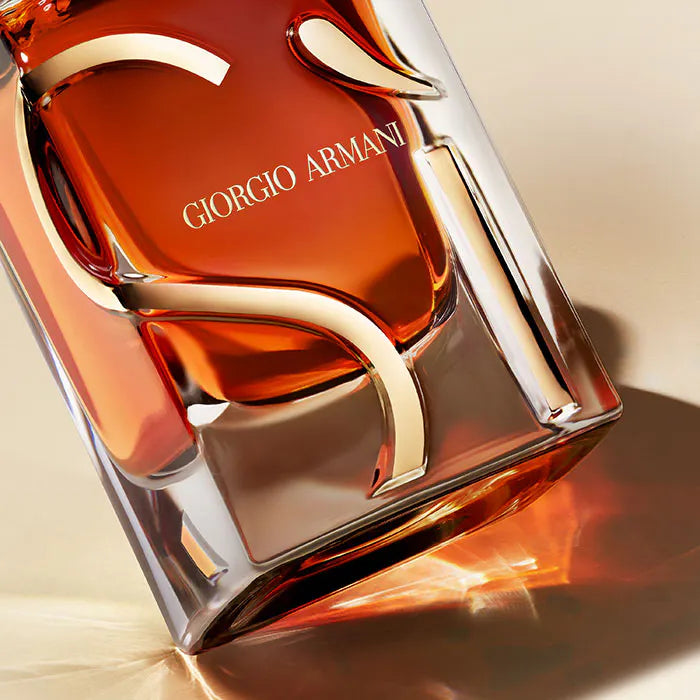 Giorg perfume bottle with a warm orange hue on a beige background