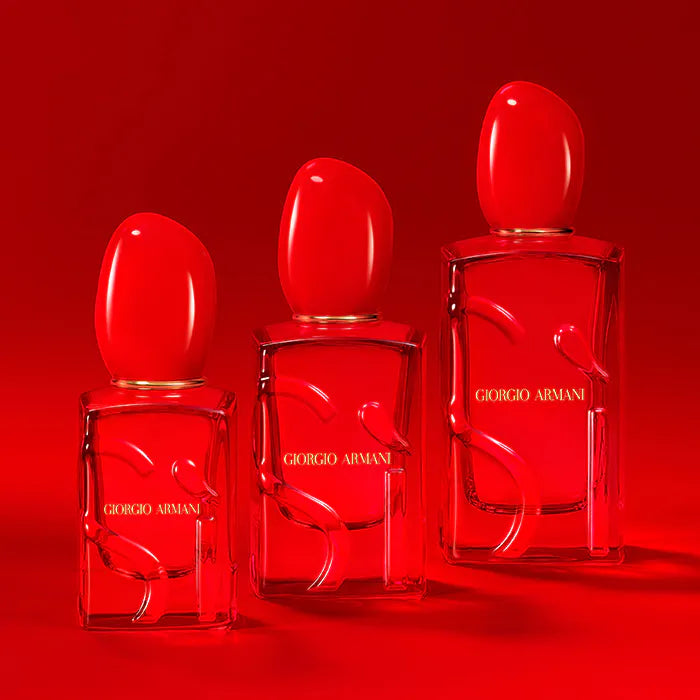 Three Giorgio perfume bottles on a red background
