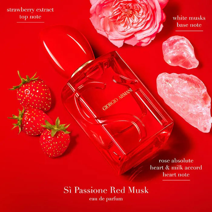 Giorgio Si Passione Red Musk perfume bottle with strawberries, rose, and crystals on a red background