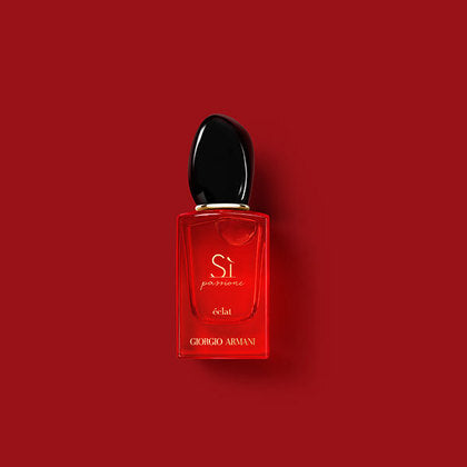Red perfume bottle with black cap on a red background