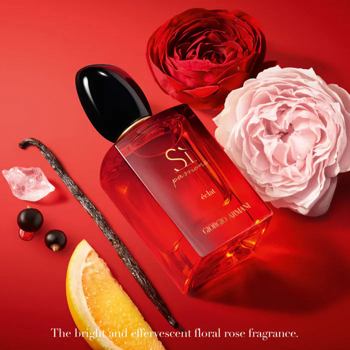 Perfume bottle with flowers and vanilla bean on a red background