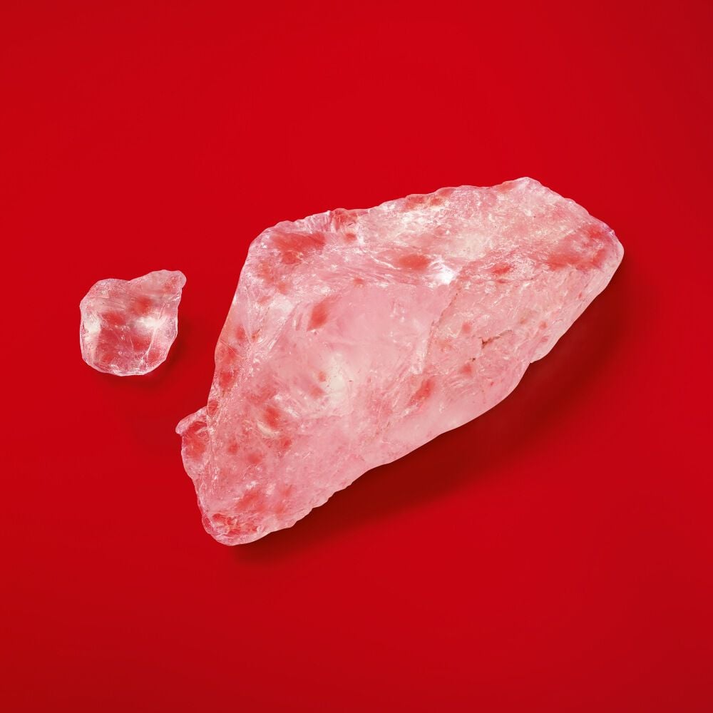 Two pink crystals on a red background