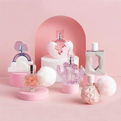Collection of perfume bottles on a pink background