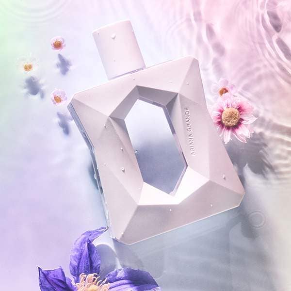 Geometric perfume bottle with flowers on a soft background