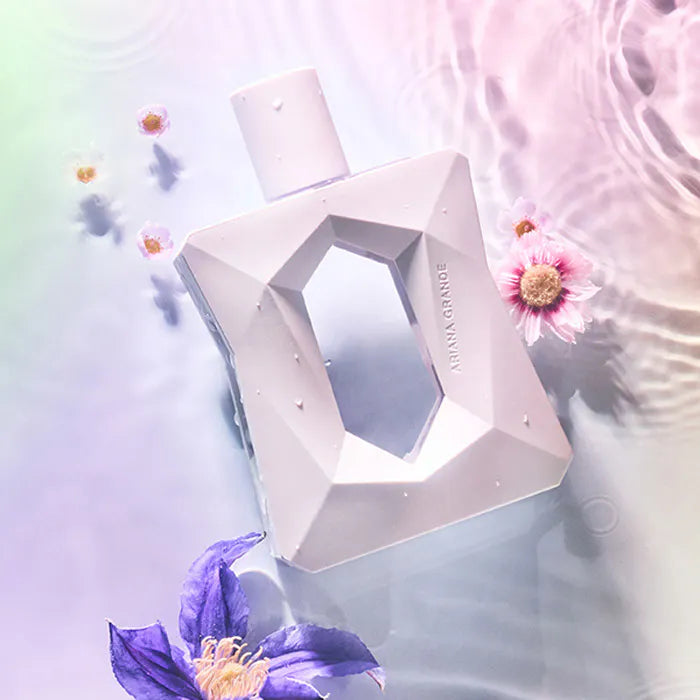 Geometric perfume bottle with flowers on a soft background