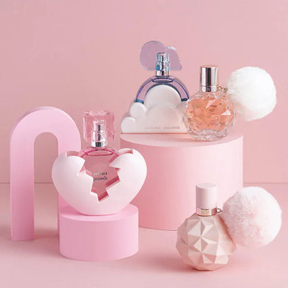 Collection of perfume bottles on a pink background