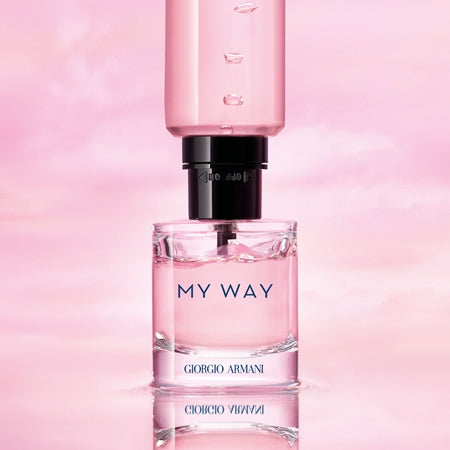 Perfume bottle labelled 'My Way' by Giorgio on a pink background