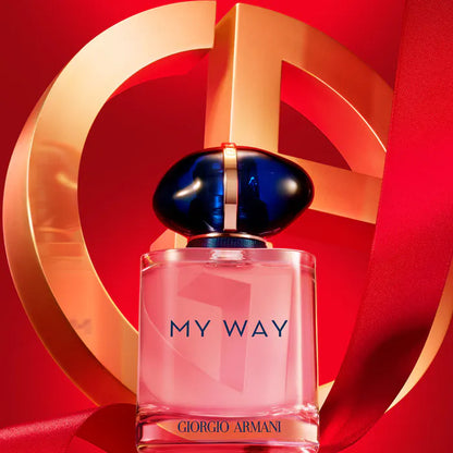 Perfume bottle labeled 'My Way' by Giorgio on a red background with brand logo.