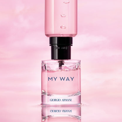 Perfume bottle labeled 'My Way' by Giorgio on a pink background