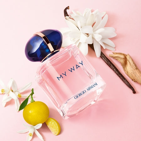 Giorgio Armani 'My Way' perfume bottle with flowers and a lemon on a pink background