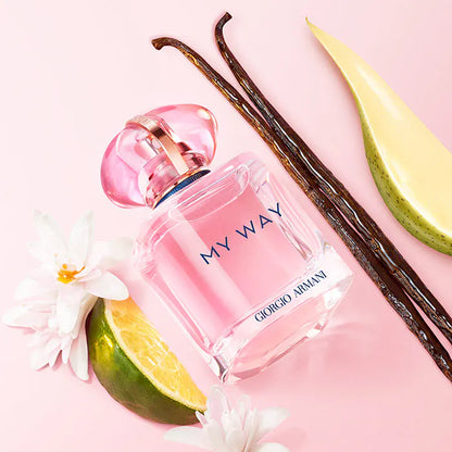 Giorgio  'My Way' perfume bottle with vanilla beans and lime on a pink background