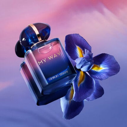 Perfume bottle labeled 'My Way' by Giorgio with a blue flower on a gradient background