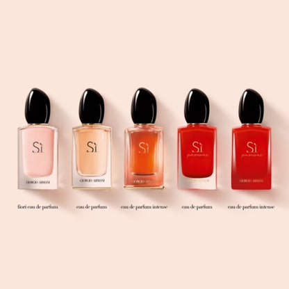 Five Giorgio  Si perfume bottles in various colors on a beige background