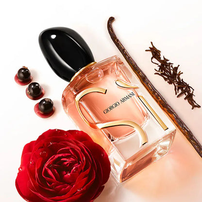 Giorgio perfume bottle with a red rose and vanilla bean on a white background