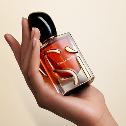 Giorg perfume bottle held in a hand against a beige background
