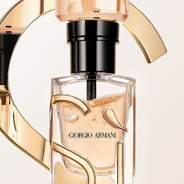  perfume bottle with gold and black design on a light pink background