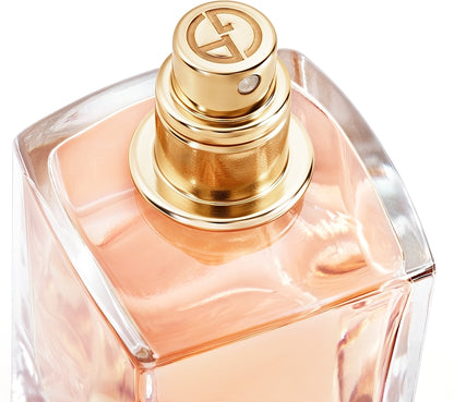 Perfume bottle with gold cap on a white background