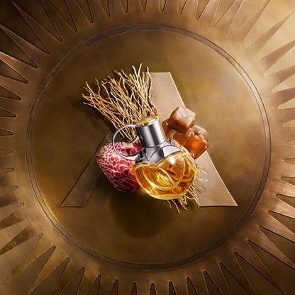 Perfume bottle with decorative elements on a circular, textured background