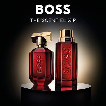 Two red BOSS perfume bottles on a reflective surface with a dark background
