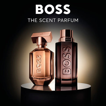 Two BOSS perfume bottles on a reflective surface with a dark background