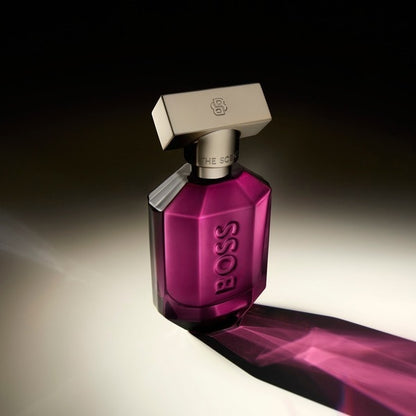 Purple perfume bottle with silver cap on a gradient background