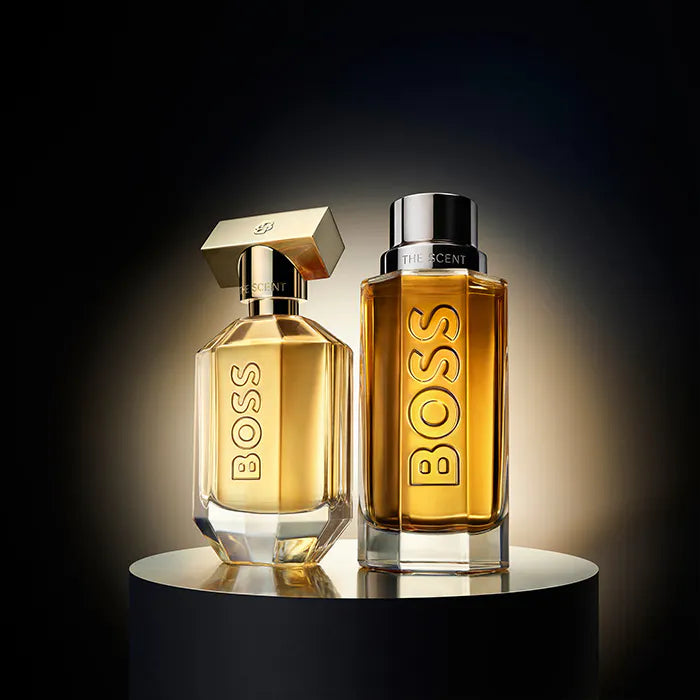 Two BOSS perfume bottles on a dark background