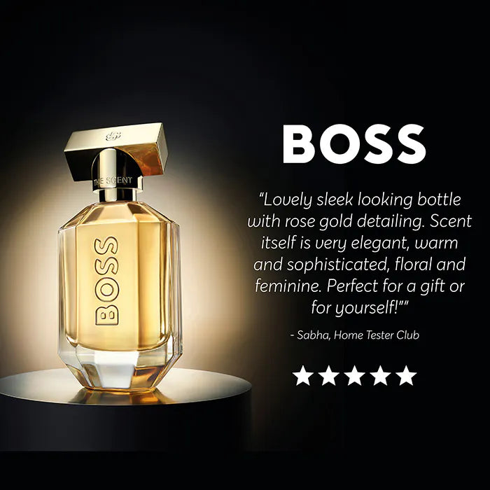 BOSS perfume bottle with gold detailing on a dark background