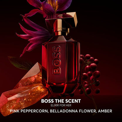 BOSS The Scent perfume bottle with flowers and gemstones on a dark background